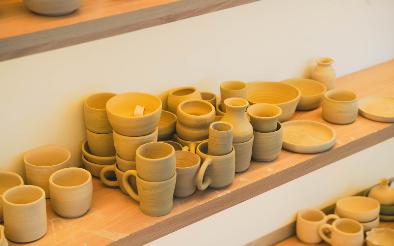 well-organized craft space at Art Barn with pottery on display